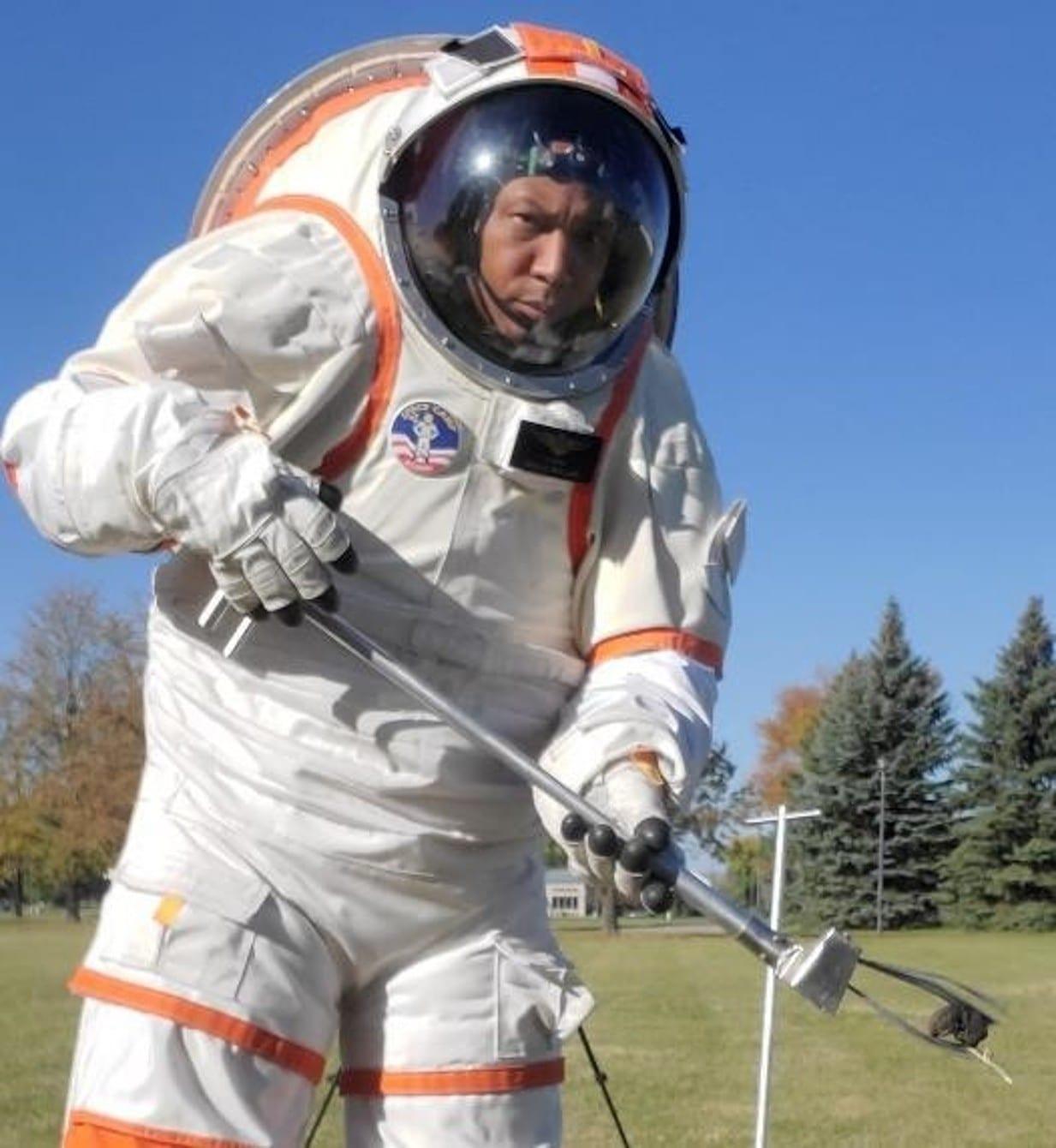 Educator donning an analog spacesuit